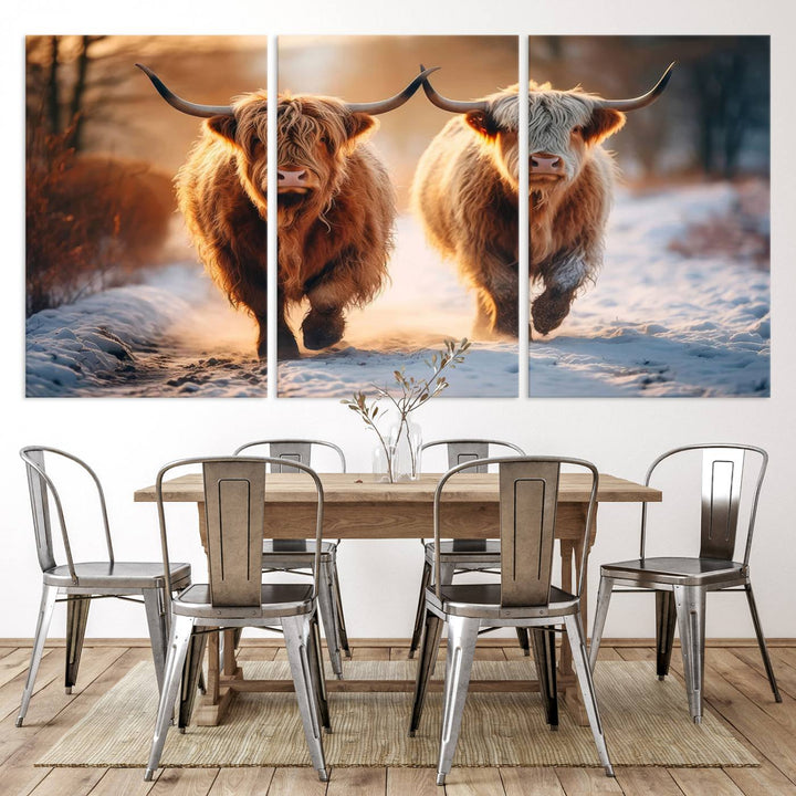 The wall art is a Scottish Highland Cow Horn canvas print featuring cows on a snowy path bathed in warm sunlight, serving as a rustic decor piece.