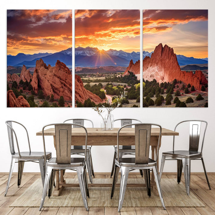 A vibrant sunset over the Rocky Mountains with red rocks.