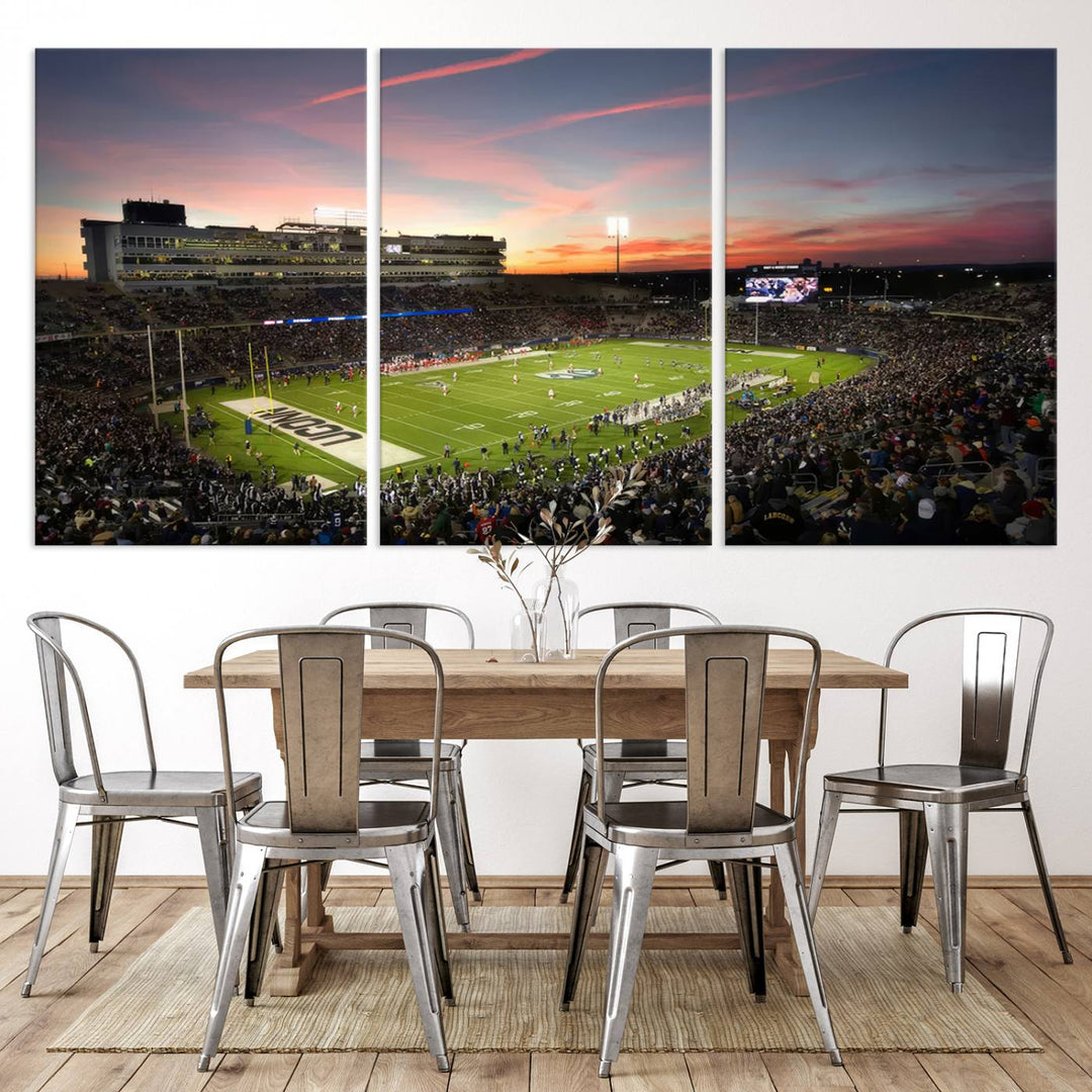 This wall art canvas print captures UCONN Huskies fans energizing a sunset scene at East Hartfords Pratt & Whitney Stadium.