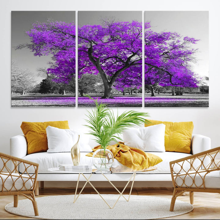 The Big Purple Tree Wall Art Canvas Print showcases a vibrant purple tree set against a black-and-white landscape.