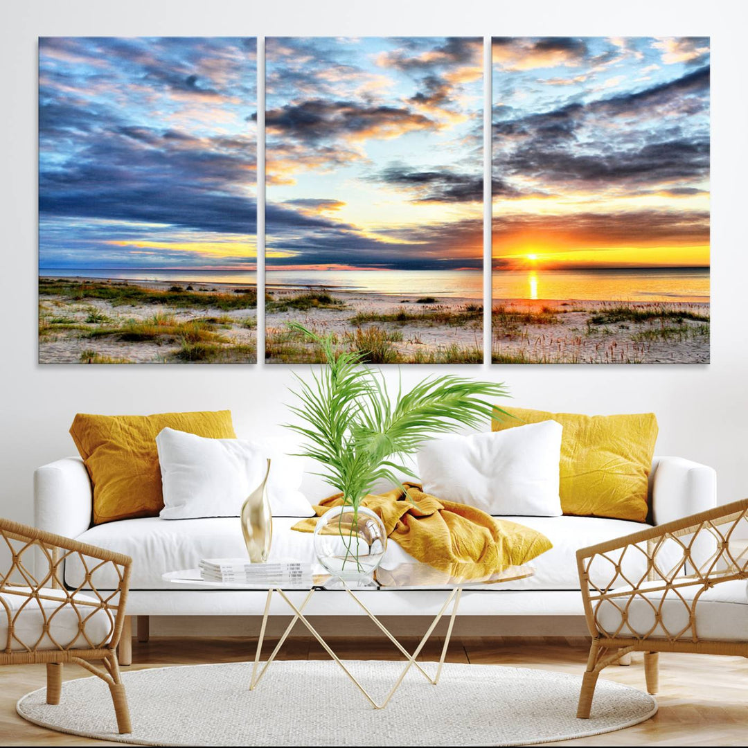 The Sunset On The Ocean canvas wall art features a beautiful beach sunset with grass and clouds.