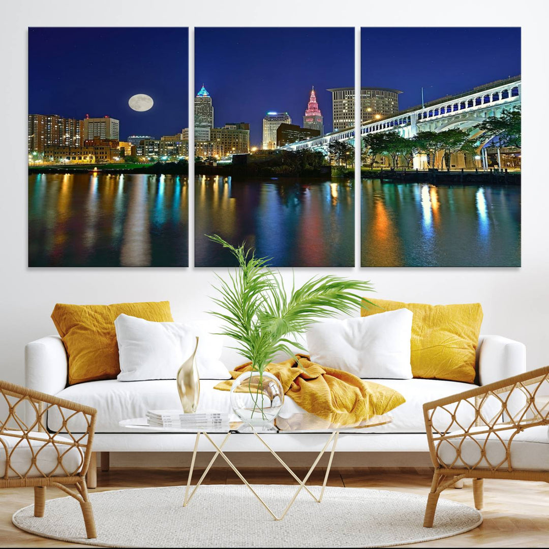 Cleveland City Lights Night Skyline Wall Art canvas showcases a moonlit cityscape reflected on water.