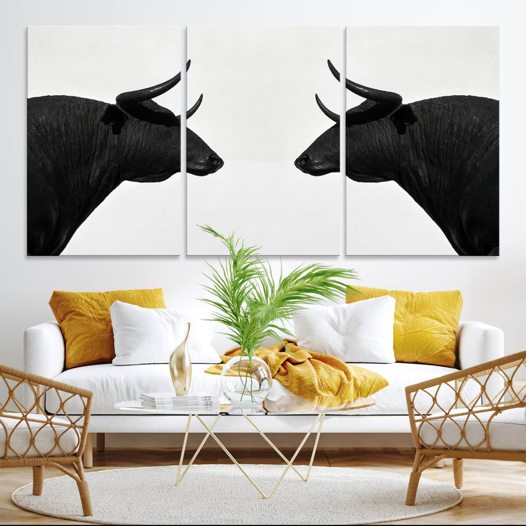 A framed canvas print featuring two black bull silhouettes, perfect for modern rustic decor.