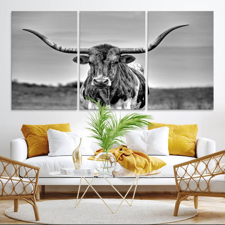 The Texas Longhorn Cow wall art, divided into three panels, is of gallery quality and displayed on a dark wall.