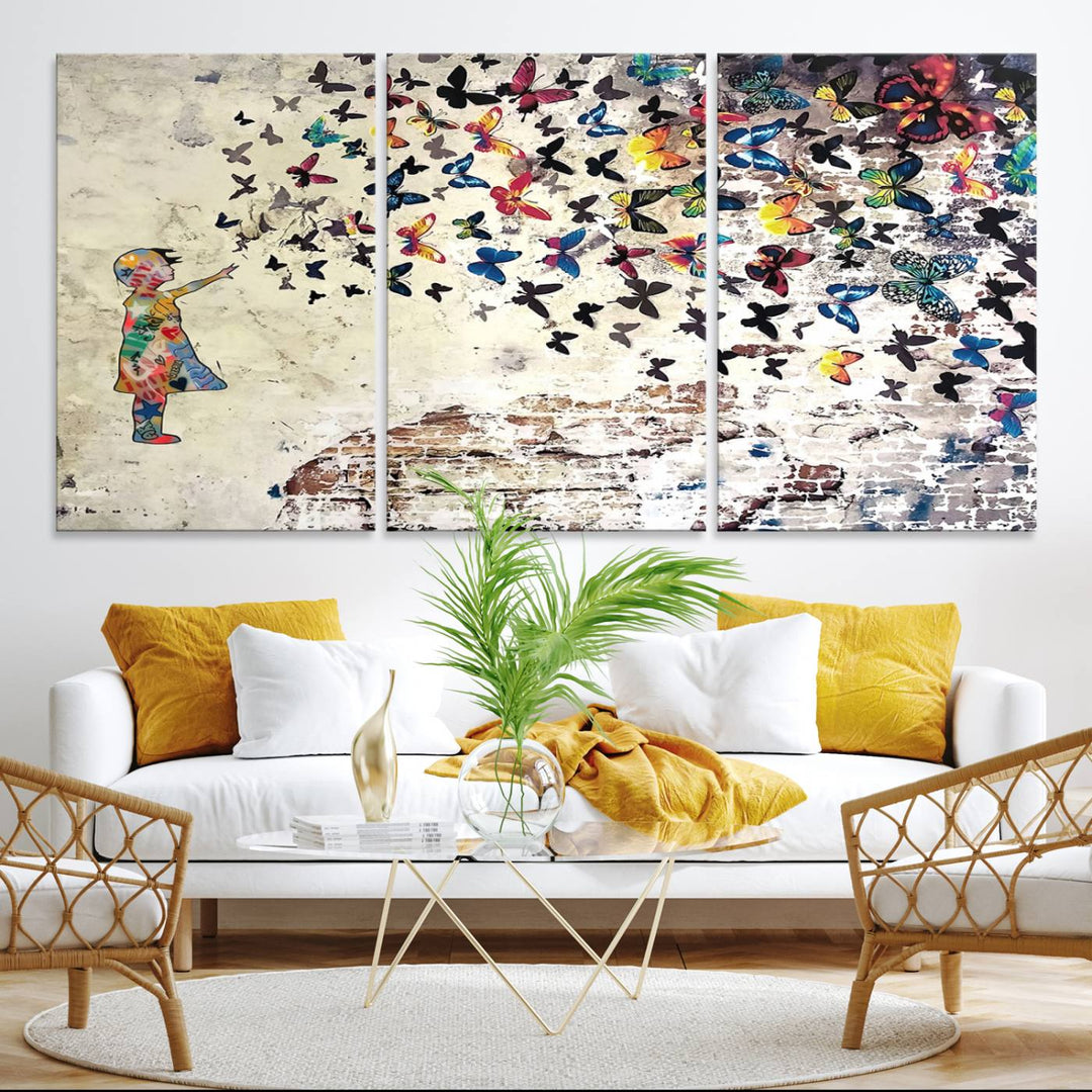 A Banksy Girl Butterfly Canvas Print is displayed on the textured wall.