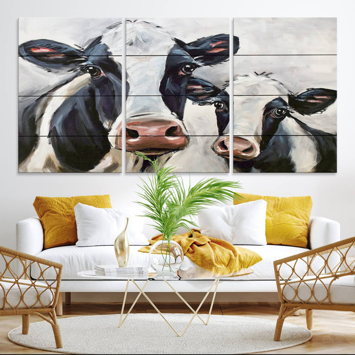 The Vintage Baby and Mom Cattle Canvas, featuring cows with black and white patches, is a prominent piece of wall art.