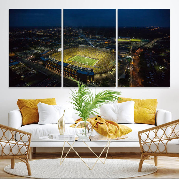 Aerial view of Michigan Stadium at night, surrounded by city lights, depicted on a Michigan Wolverines wall art canvas print.