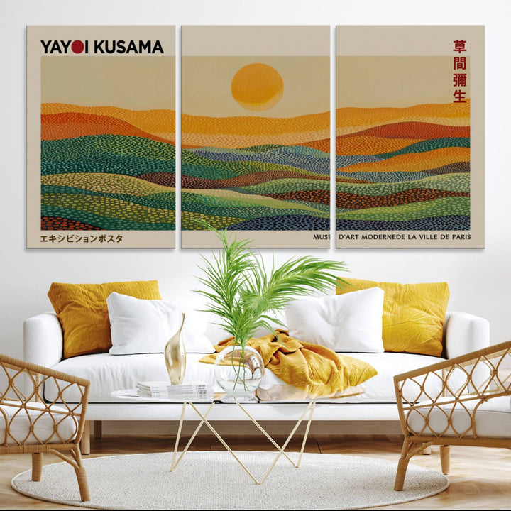 A framed Yayoi Kusama 1986 wall art print showcases a vibrant abstract landscape with colorful, wavy dots and a sun above the horizon.