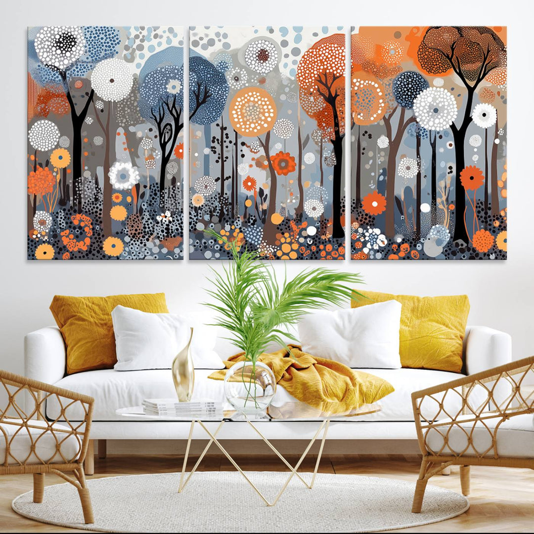 The wall art features stylized trees and flowers in blue, orange, and gray, forming an abstract winter landscape on canvas.