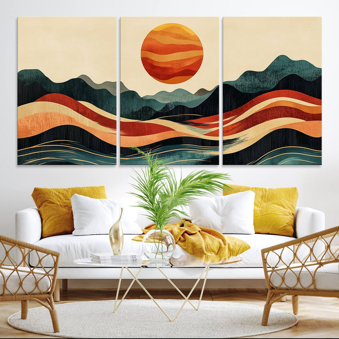 The Mountain Triptych wall art, featuring a design of the sun, mountains, and waves, is displayed prominently on the wall.