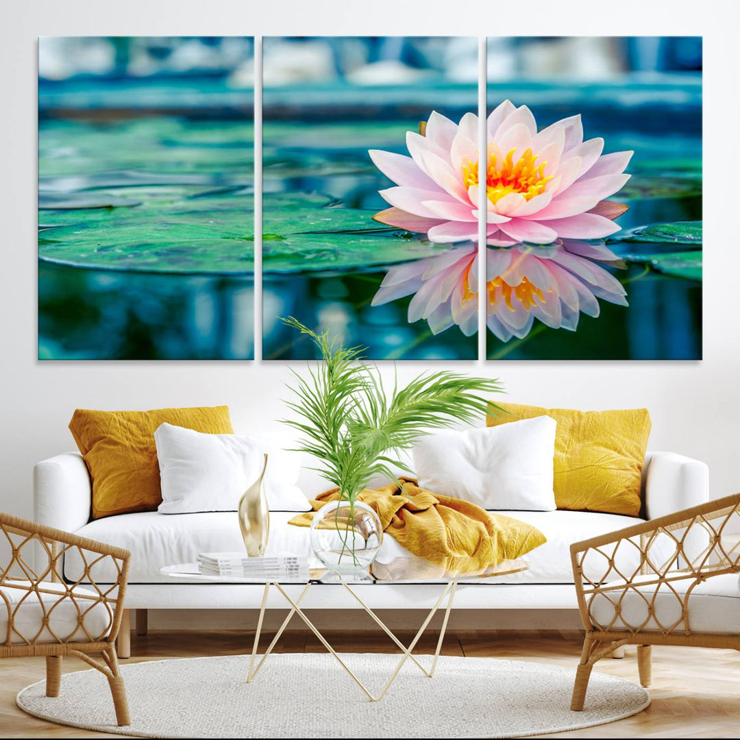 The Lotus Flower Canvas Print showcases a pink water lily with a yellow center gracefully floating on a calm pond.