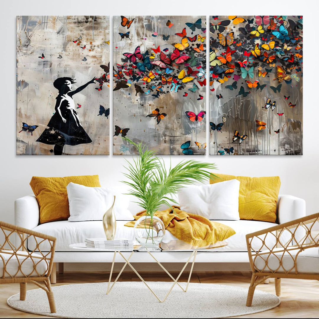 The Banksy Butterfly Girl 3-Piece Modern Graffiti Canvas Wall Art features a silhouette of a girl reaching for butterflies.