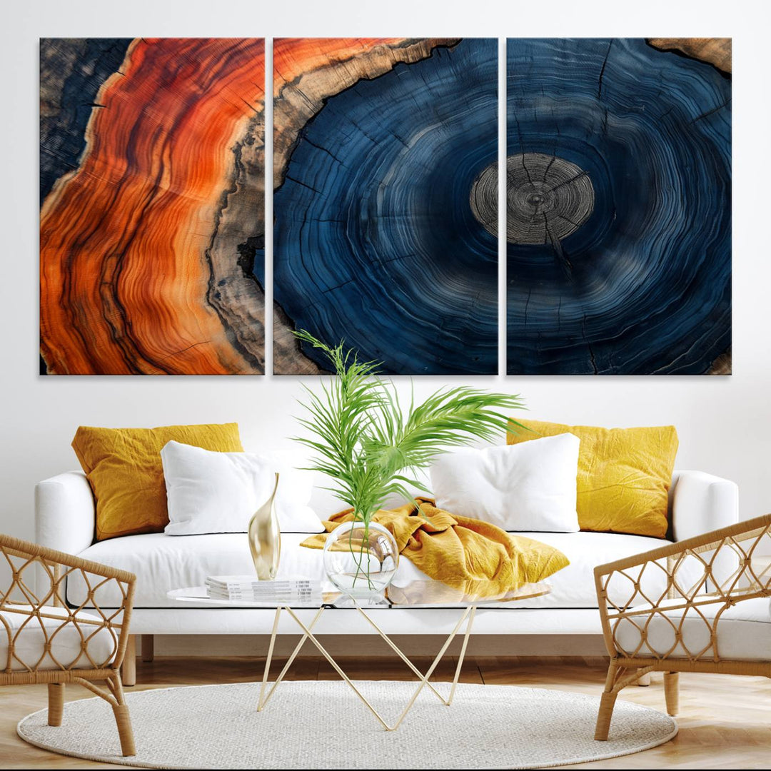 Abstract Tree Ring Wall Art Print on canvas featuring vibrant blue, orange, and brown rings with a natural rustic wood texture. Free shipping available!.