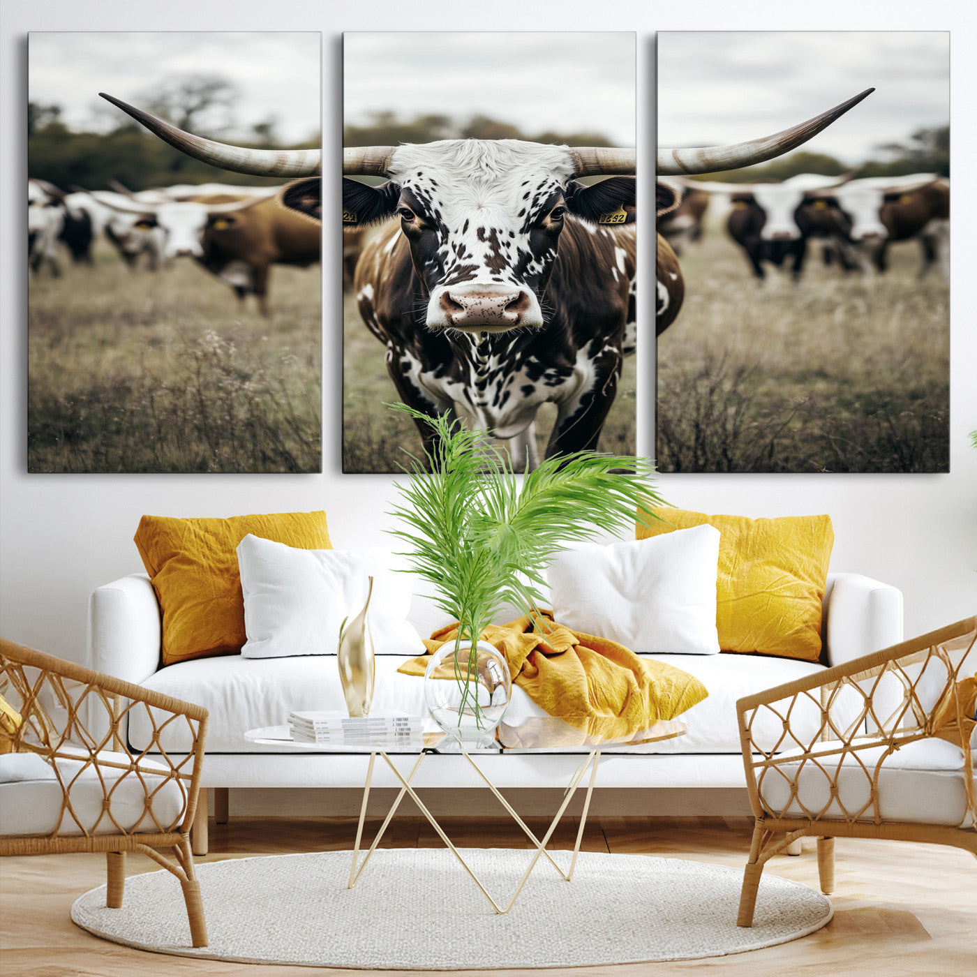 Canvas of a speckled Texas longhorn standing boldly in a field with a herd behind, perfect for rustic western or farmhouse wall decor.