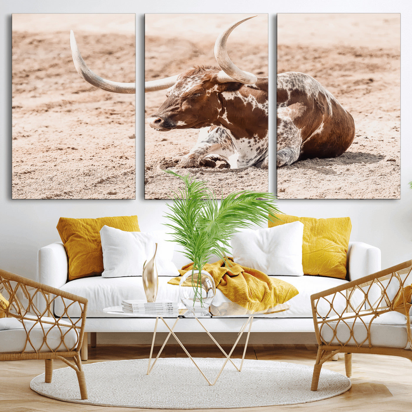 Texas Longhorn bull resting on dusty ground with warm tones, ideal for rustic western or farmhouse-themed wall decor.