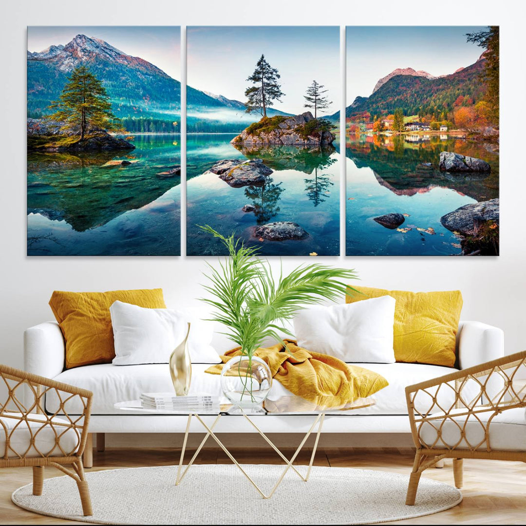 The 3-panel wall art showcases a serene mountain lake with rocky islands and trees, creating an ideal focal point for dining rooms or offices.