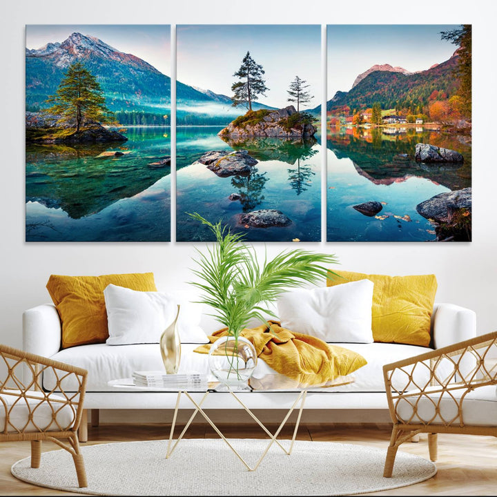 The 3-panel wall art showcases a serene mountain lake with rocky islands and trees, creating an ideal focal point for dining rooms or offices.