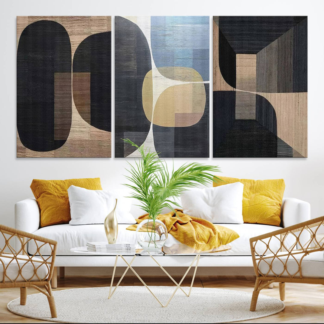 Abstract geometric wall art featuring black, gray, beige, and blue tones framed in a wooden border.