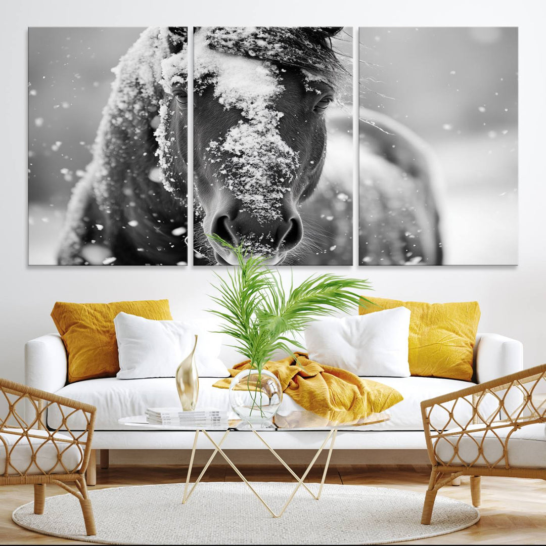 The Black and White Horse Winter Wall Art features a majestic horse with snow-covered hair set against a serene winter backdrop.