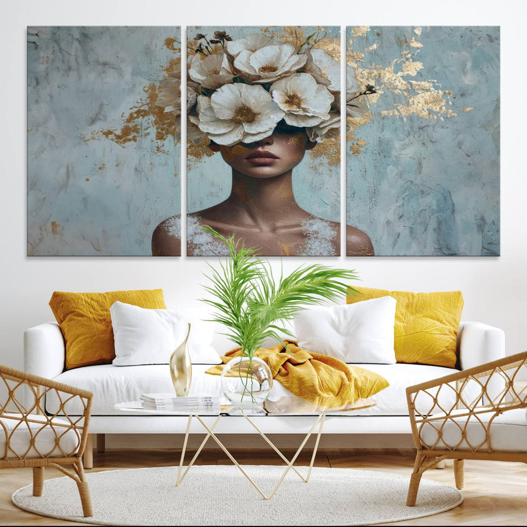 Golden Petal Wall Art: A womans face adorned with a gold floral design on a teal background, presented in a 3-panel modern glam canvas.