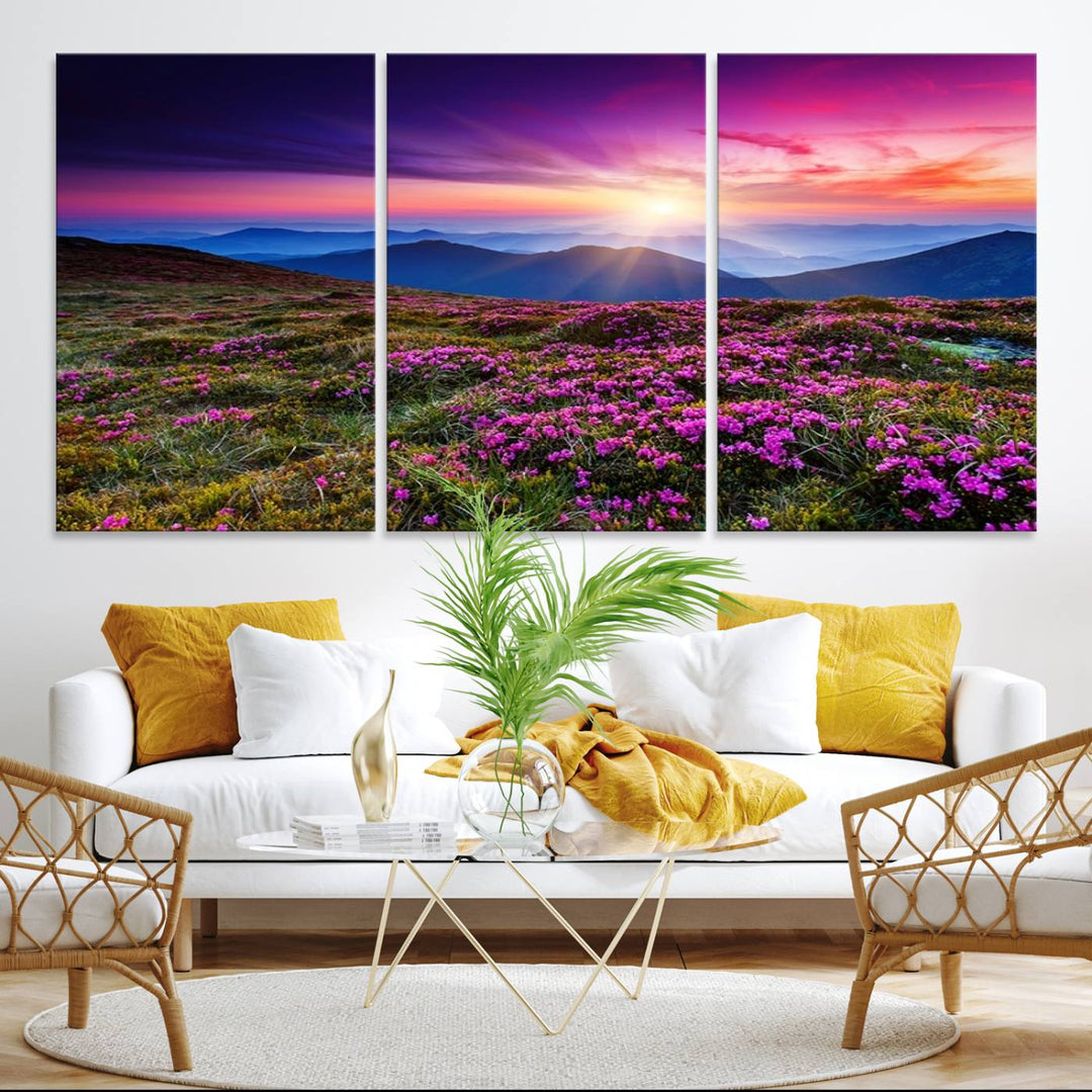 A 3-panel landscape photography canvas of a sunset over mountain meadows with purple wildflowers decorates the wall.