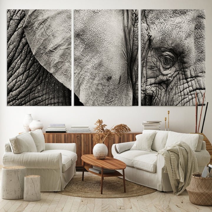 A modern living room features a large Elephant Wall Art Canvas Print in black and white, crafted on museum-quality canvases with UV-protective coating to maintain its elegance.