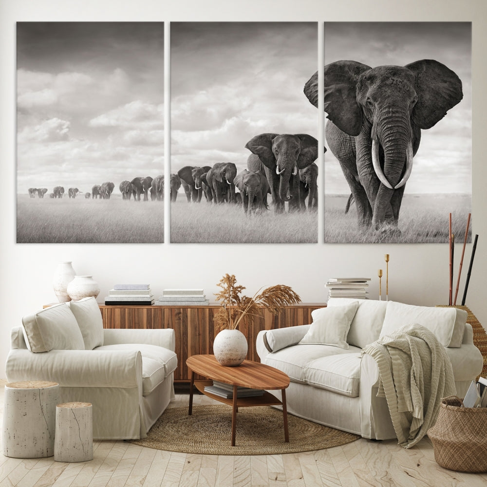 The "Herd of Elephants Wall Art Canvas Print" features an elegant black and white triptych of elephants walking in a line, beautifully displayed on museum-quality canvas with a UV-protective coating. This artwork arrives ready to hang and adds sophistication to any space.