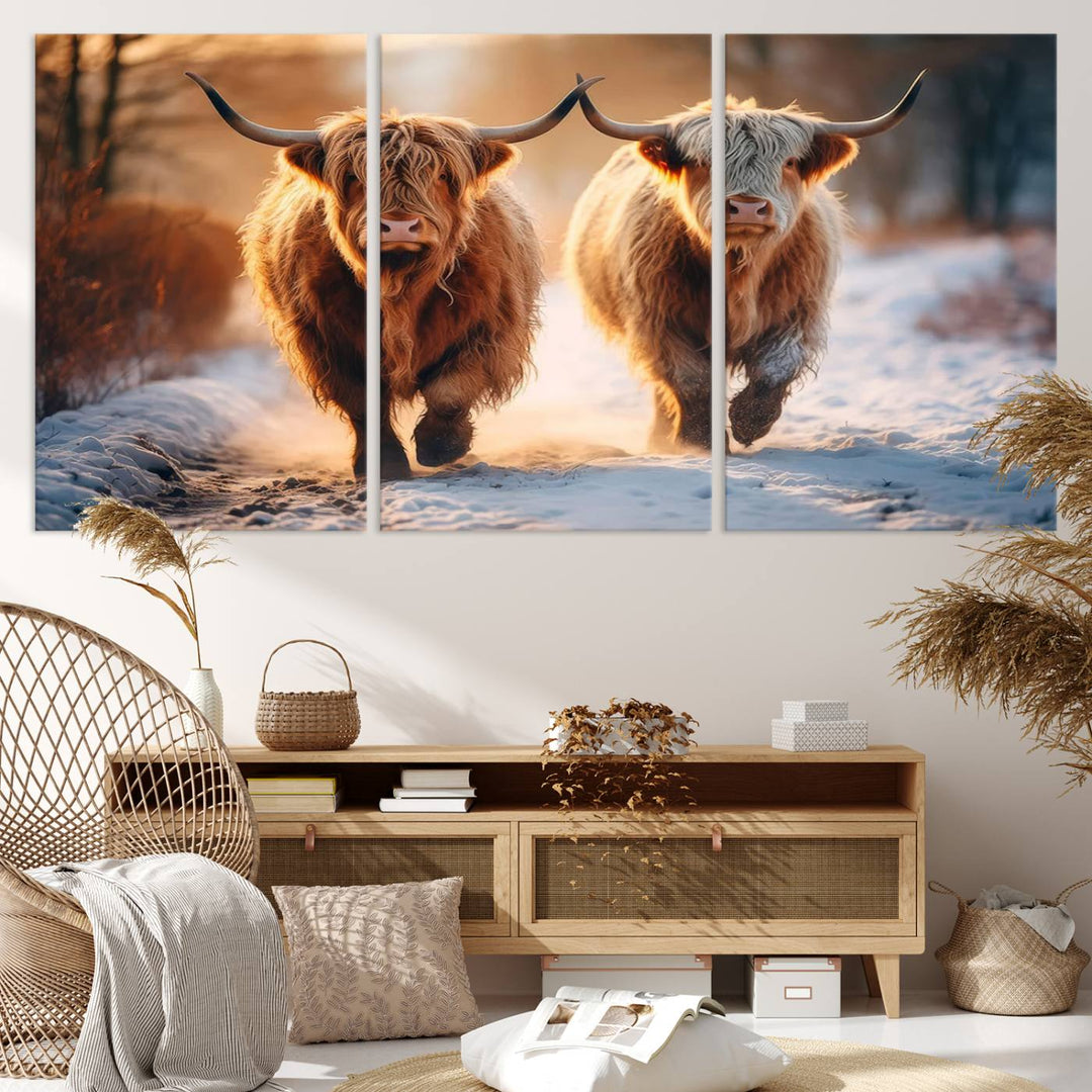 The wall art is a Scottish Highland Cow Horn canvas print featuring cows on a snowy path bathed in warm sunlight, serving as a rustic decor piece.