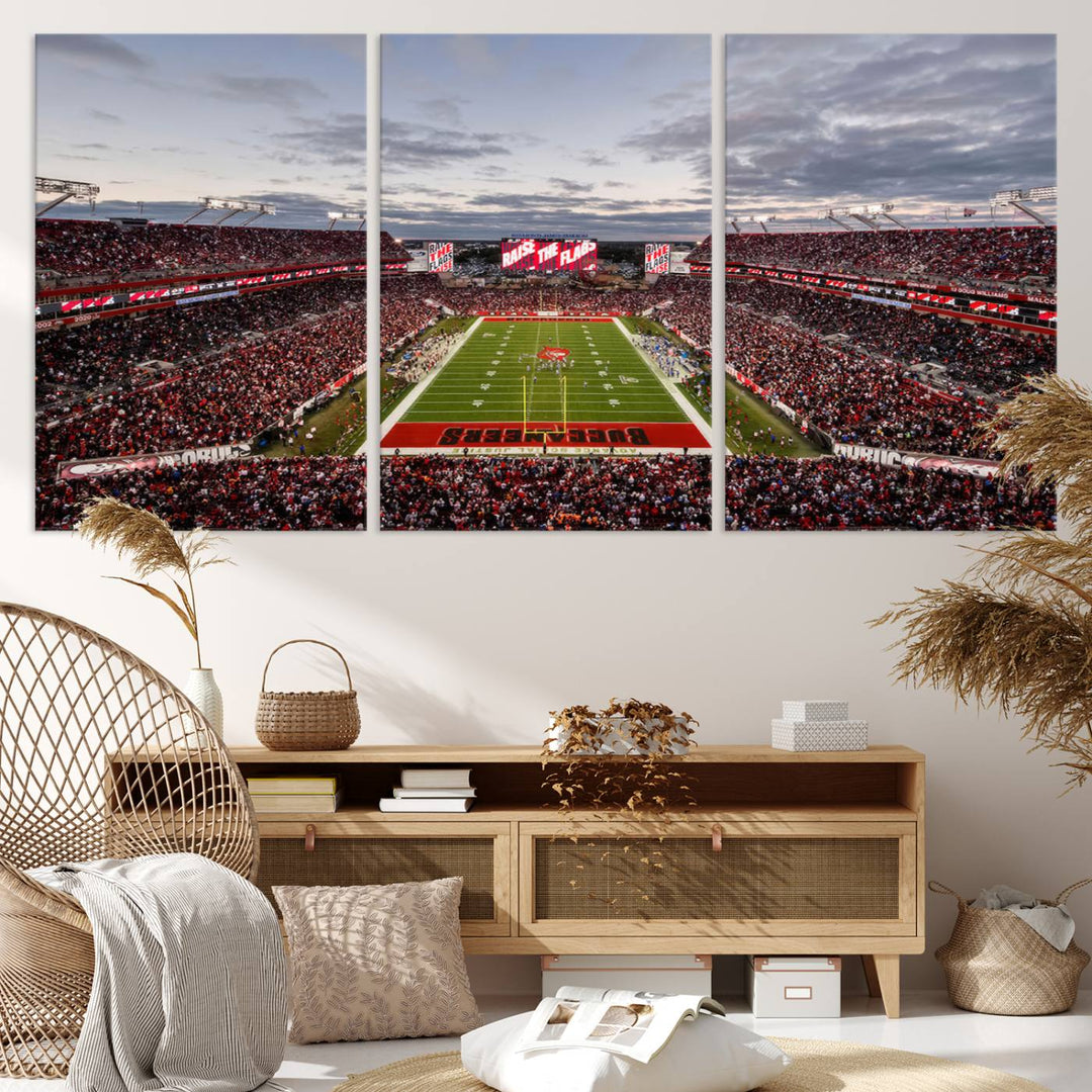 The wall art captures a stunning scene of Raymond James Stadium bathed in the warm hues of sunset. The sky, filled with clouds, provides a dramatic contrast to the vibrant lighting on the field, encapsulating the dynamic energy of a football game.