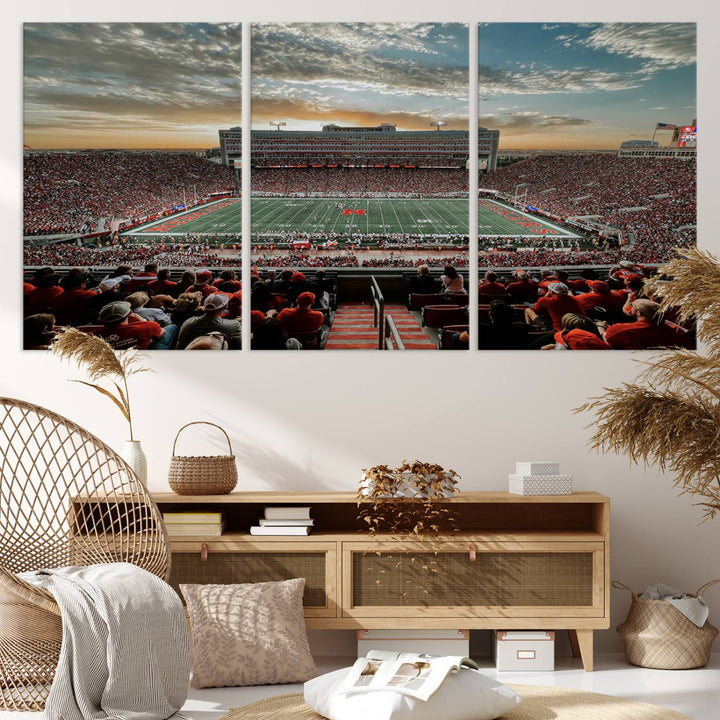 The living room features a stunning triptych of Lincoln Memorial Stadium wall art canvas print, celebrating the University of Nebraska Cornhuskers football team. This piece serves as captivating wall art, showcasing a gallery-quality finish.