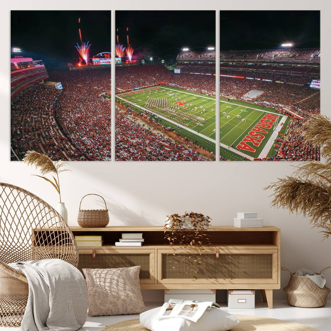 The University of Nebraska Cornhuskers Football Team Print, featuring Lincoln Memorial Stadium in a vibrant triptych canvas with fireworks above and a gallery-quality finish, is elegantly displayed.