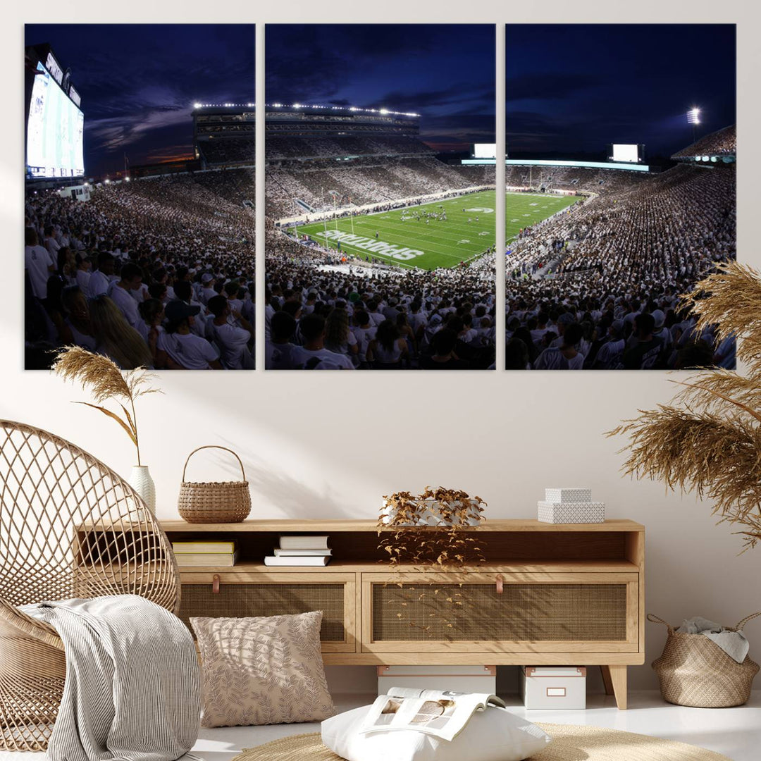 A packed football stadium at night, with bright lights and fans in white, depicted in a Michigan State Spartans Stadium wall art.