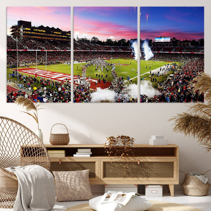 The wall art features a canvas print of the Stanford Cardinal football team, capturing players, fireworks, and smoke against the backdrop of a sunset at Stanford Stadium.