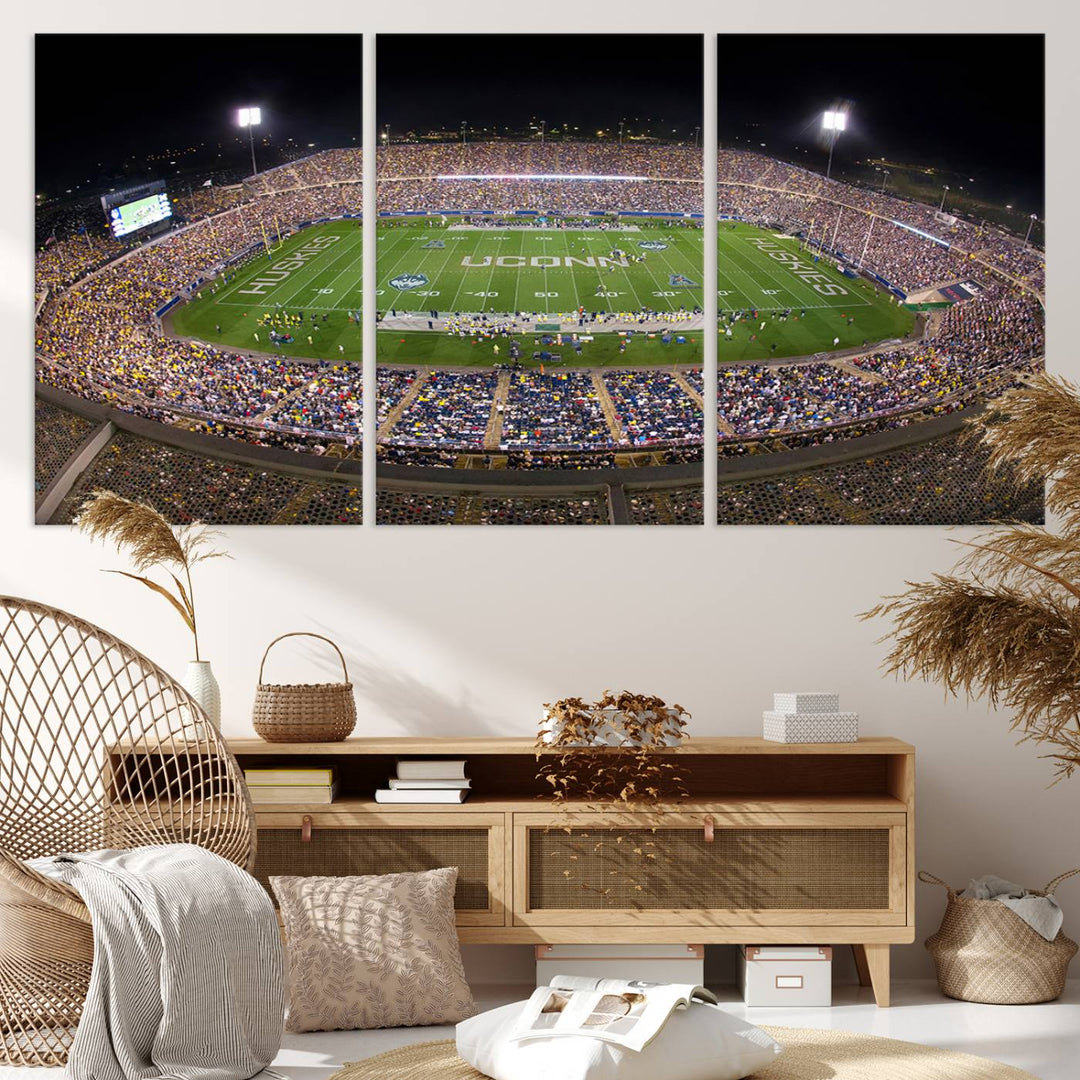 A large football stadium at night, featuring the UCONN Huskies, is depicted on the East Hartford Pratt & Whitney Stadium Wall Art Canvas Print.