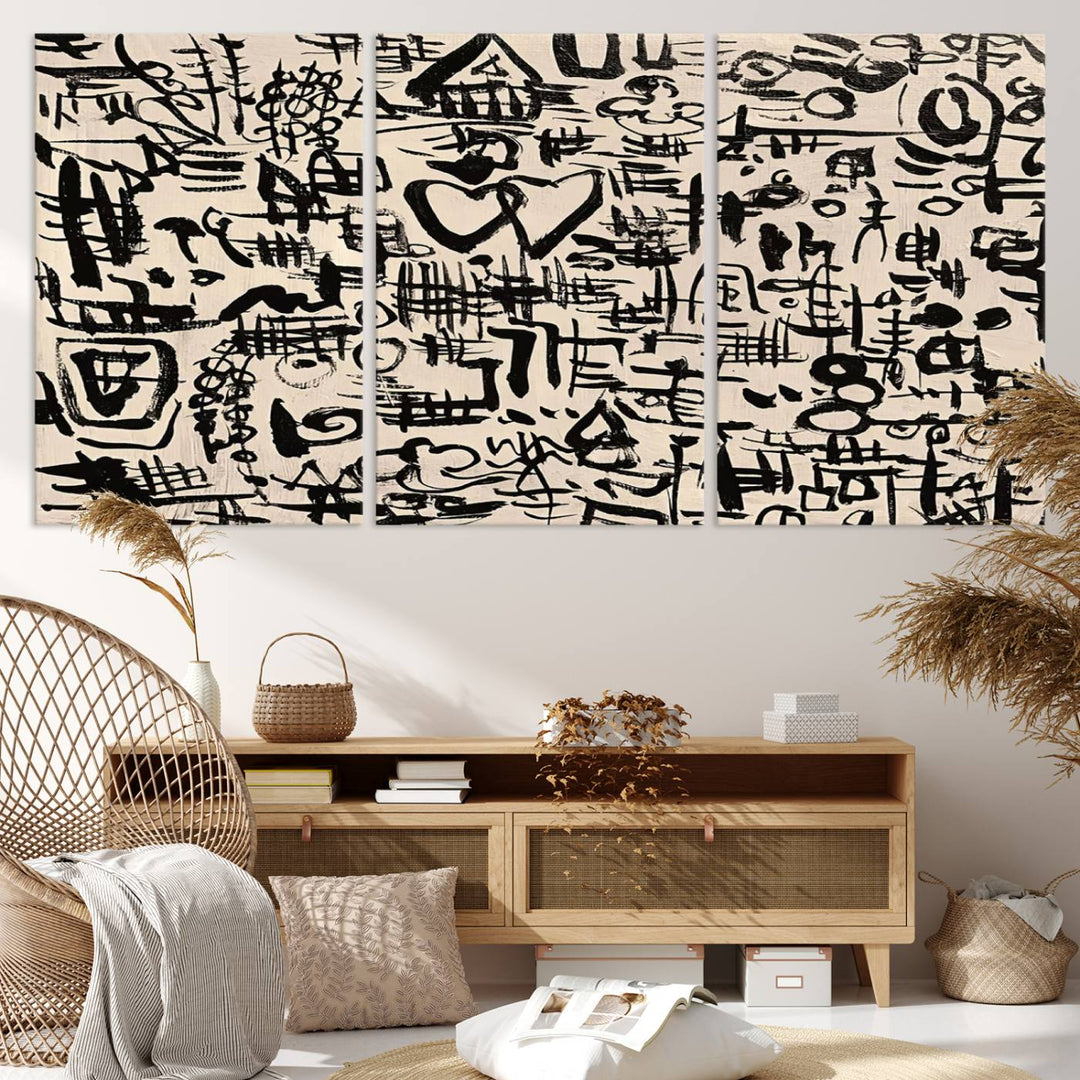 The Abstract Love and Chaos canvas is a museum-quality print featuring black symbols on a beige background, adorned with a heart and scribble design. It is framed to enhance its artistic appeal.