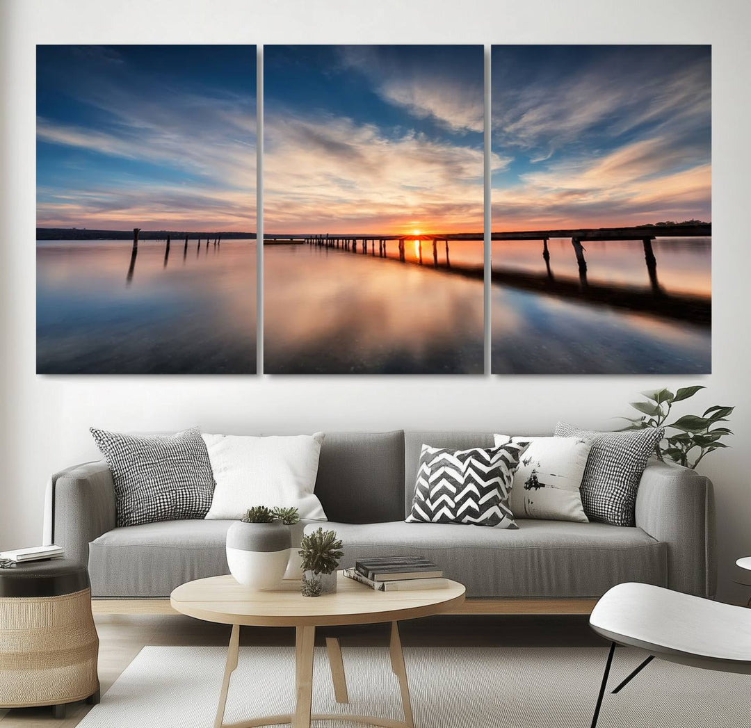 The Sunset Pier Canvas features a serene coastal landscape with vibrant hues under cloudy skies, ideal for modern decor.