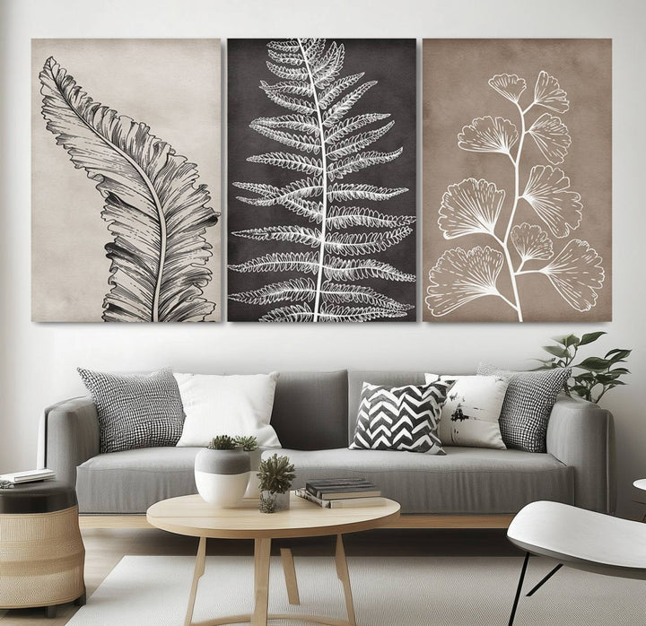 Three framed botanical wall art pieces are displayed in a bright room.