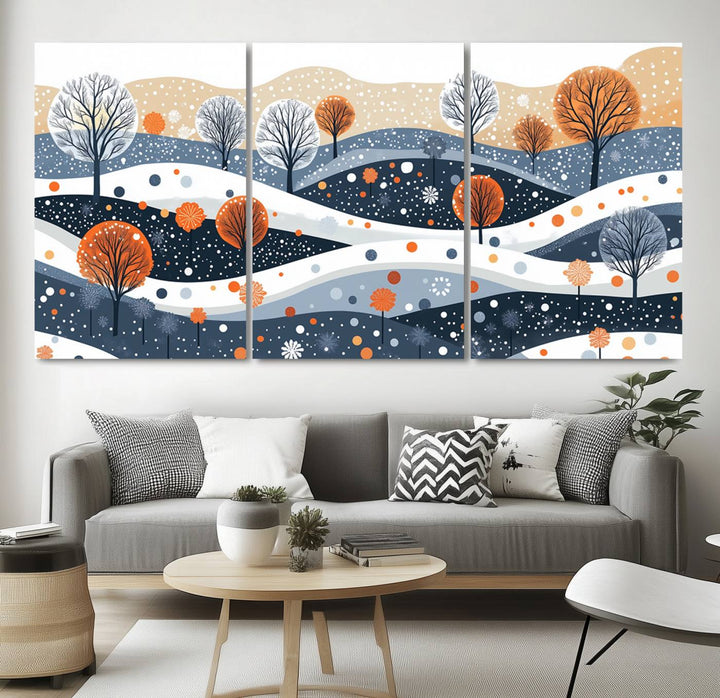 The "Abstract Winter Landscape Canvas Wall Art Print," featuring a triptych of landscapes with trees and hills in vibrant orange, white, and blue hues, adds a gallery-quality finish that transforms the space into an art lover's dream.