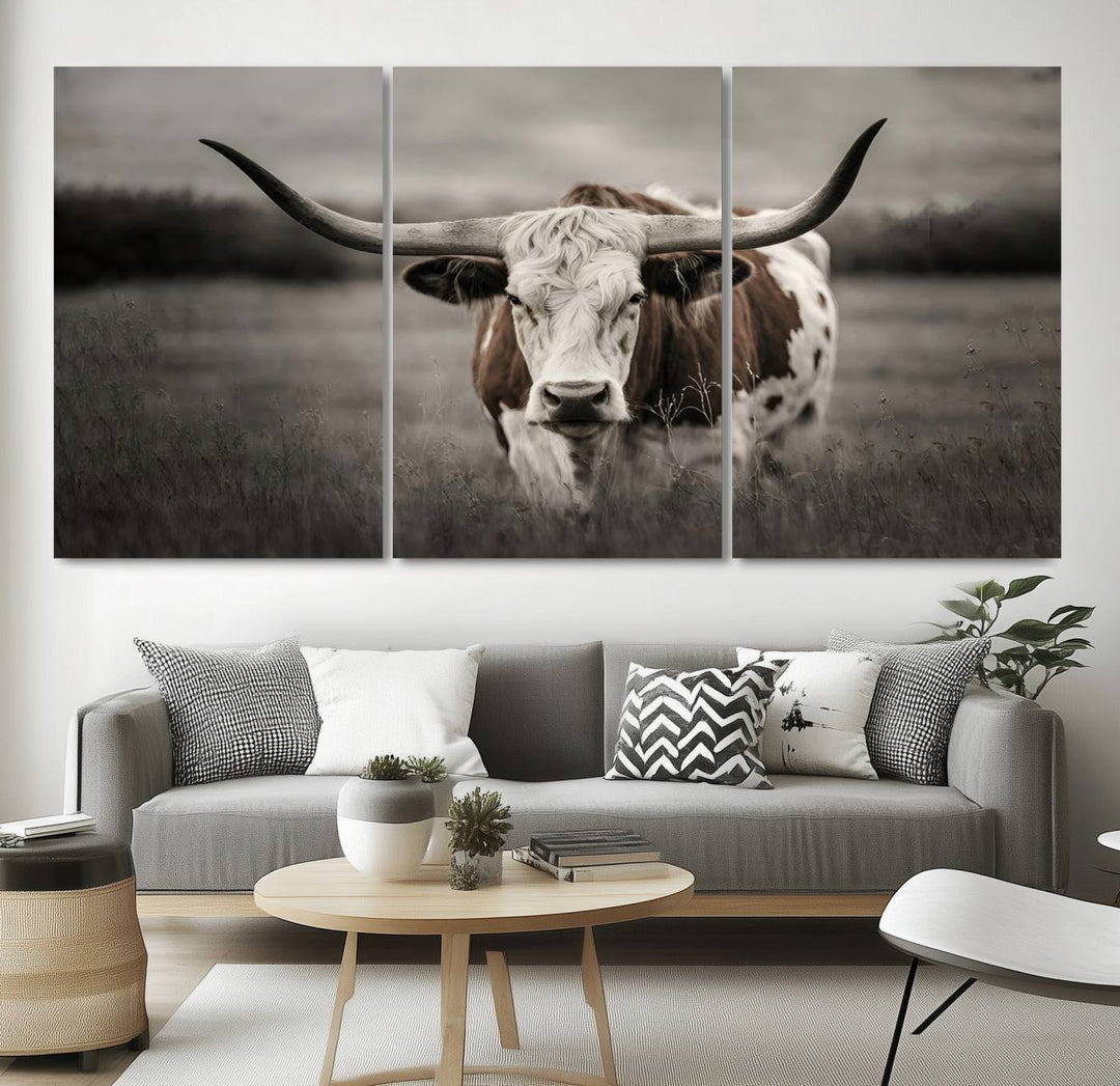 The Texas Longhorn Cow Canvas Wall Art Print adds a rustic touch to a living room.