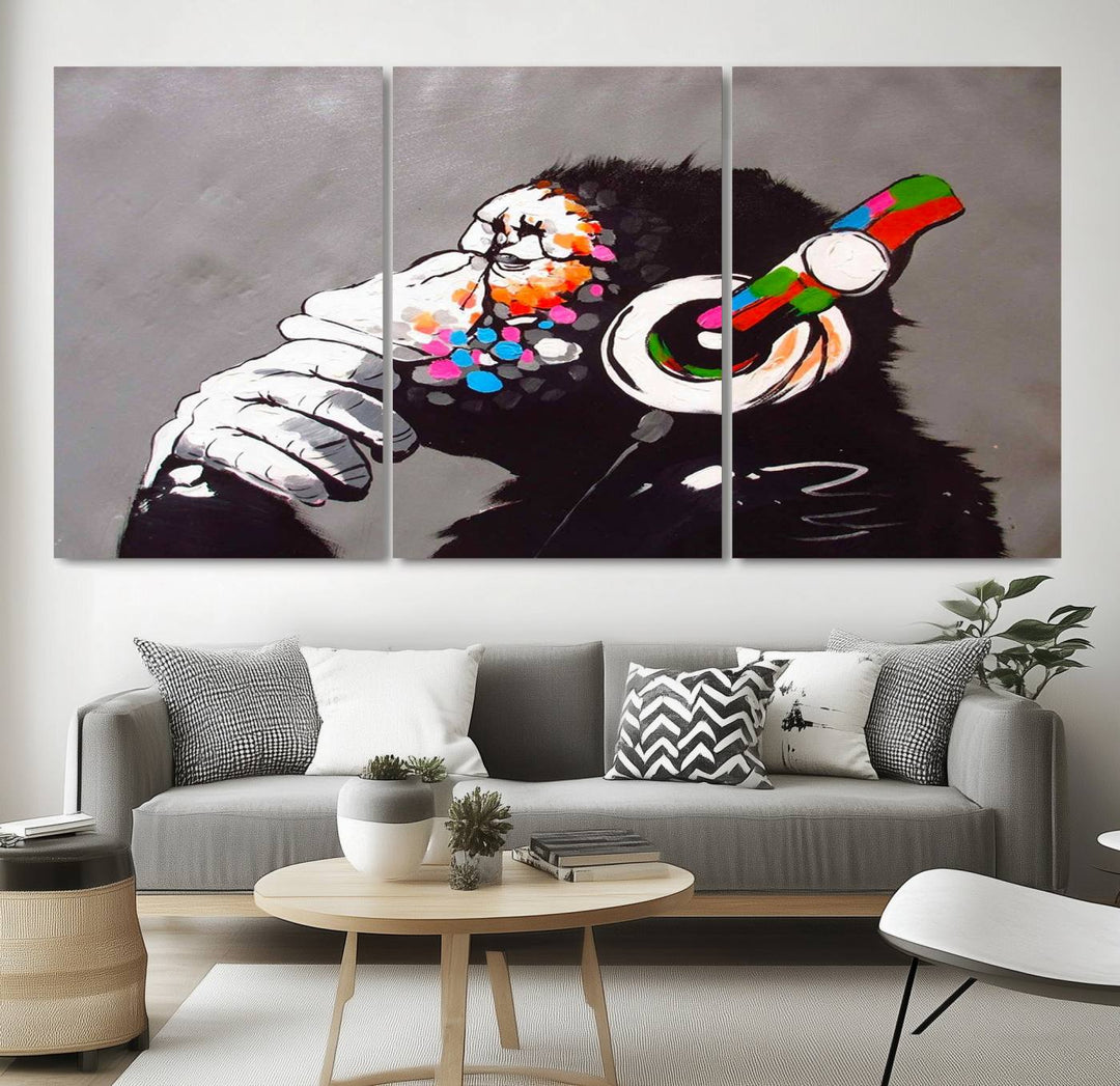 A vibrant triptych, the "DJ Monkey Listening to Music" wall art print, features a Banksy-inspired large canvas adorned with colorful modern pop art. This striking piece elegantly enhances the room with its dynamic and lively depiction.