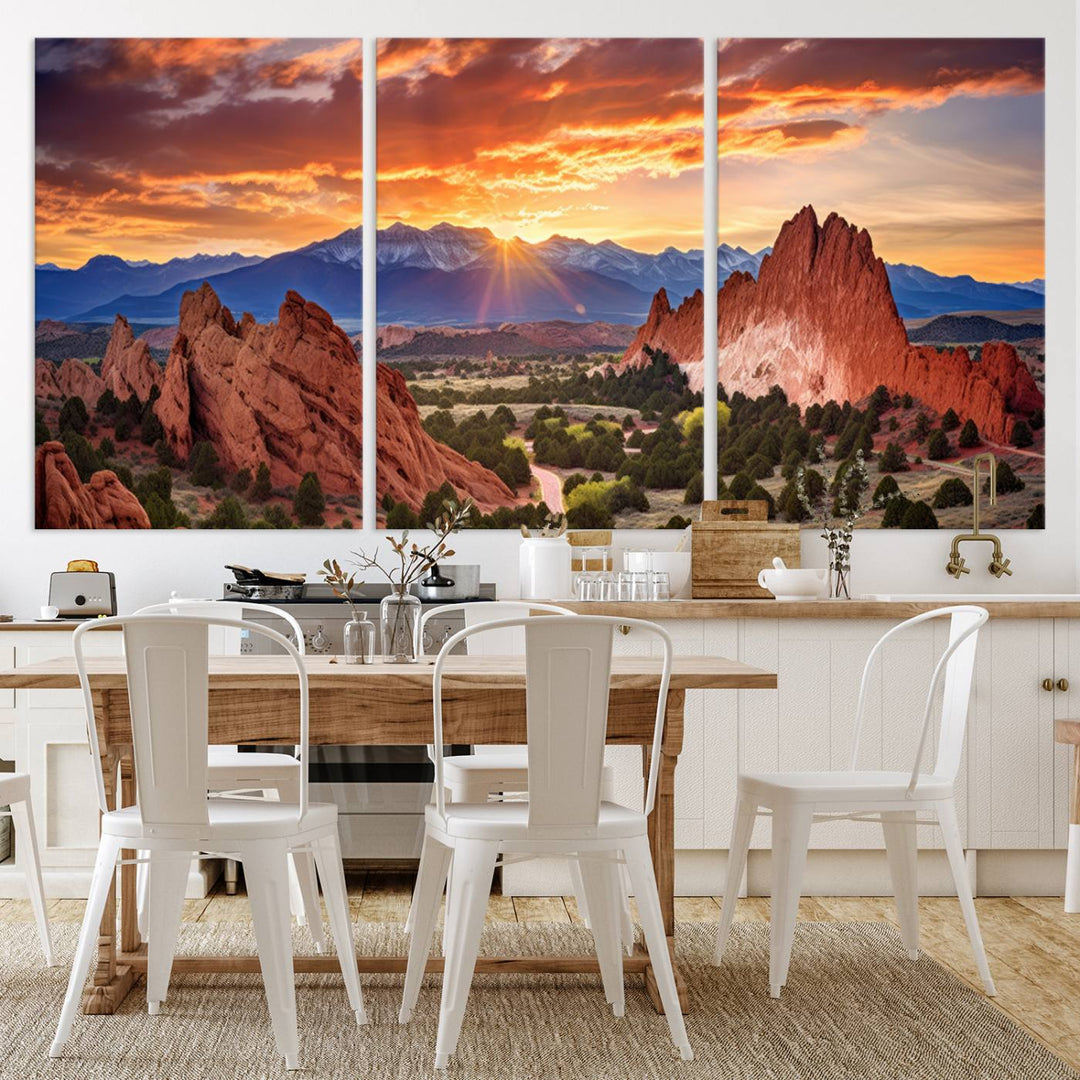A vibrant sunset over the Rocky Mountains with red rocks.
