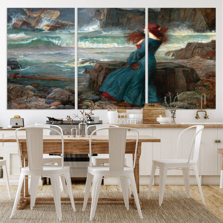 The Miranda by the Shore Wall Art Canvas Print depicts a woman in a blue dress standing by the sea, watching a shipwreck.