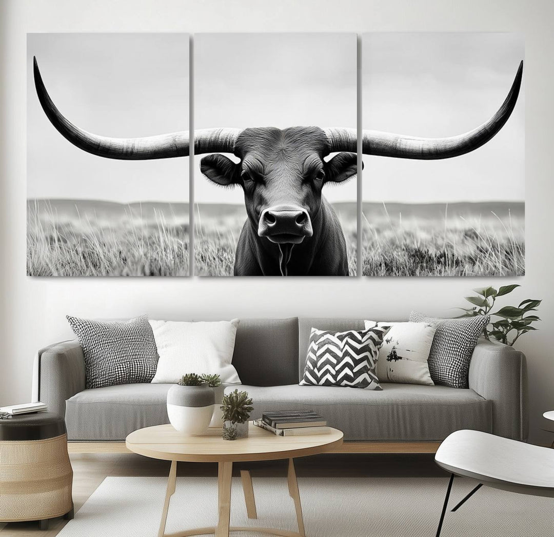 A stylish living room showcases a Longhorn Bull Canvas Print, expertly enhancing the decor with a hint of rustic farmhouse charm.