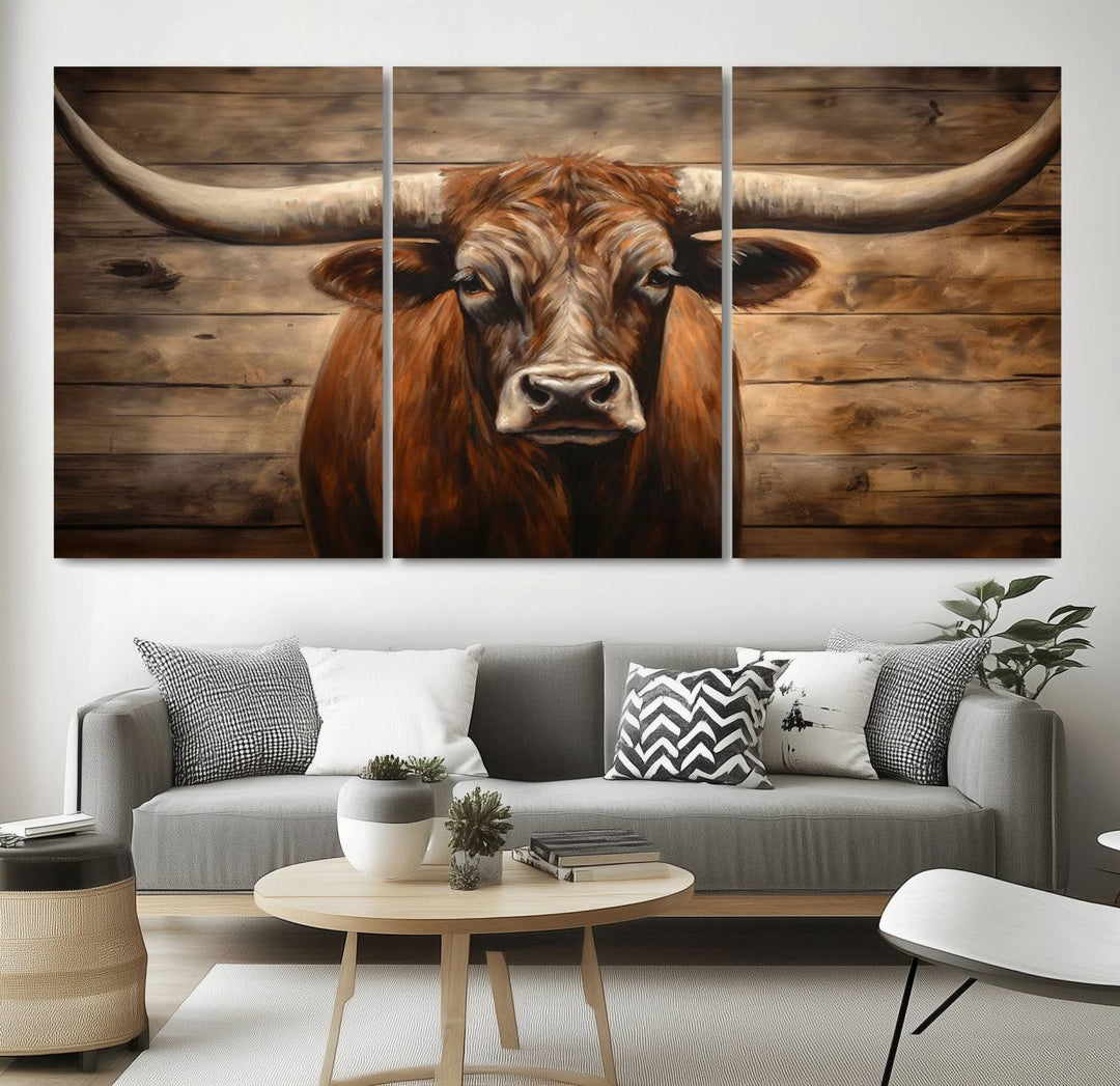 The Longhorn Bull Wall Art, a ready-to-hang canvas print, showcases an image of a brown longhorn cow set against a wooden background, perfect for those looking to enhance their space with rustic farmhouse and western barn decor.