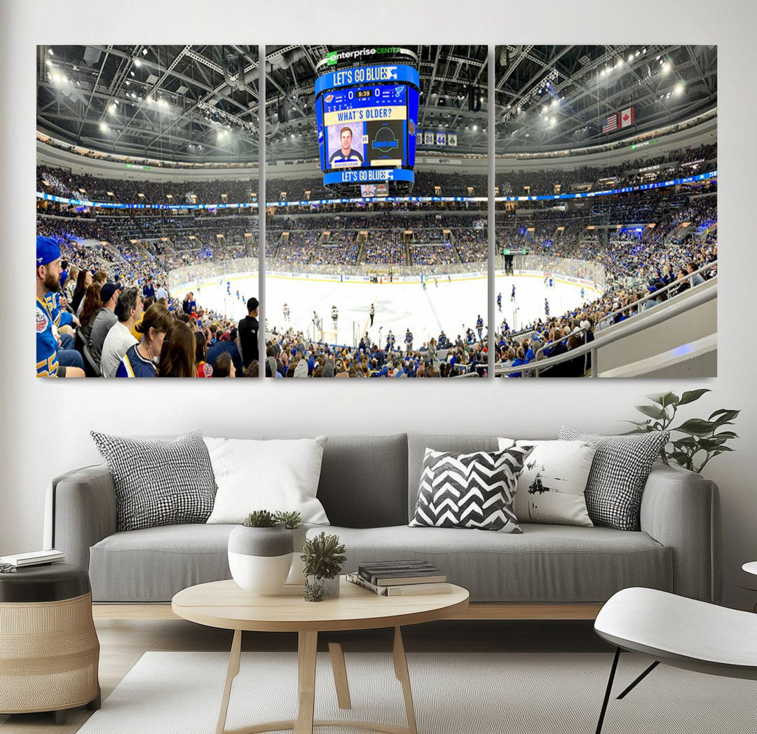 Wall art prints depicting the bustling scenes of the St. Louis Blues being cheered on by a full house at the Enterprise Center, beneath a large scoreboard.