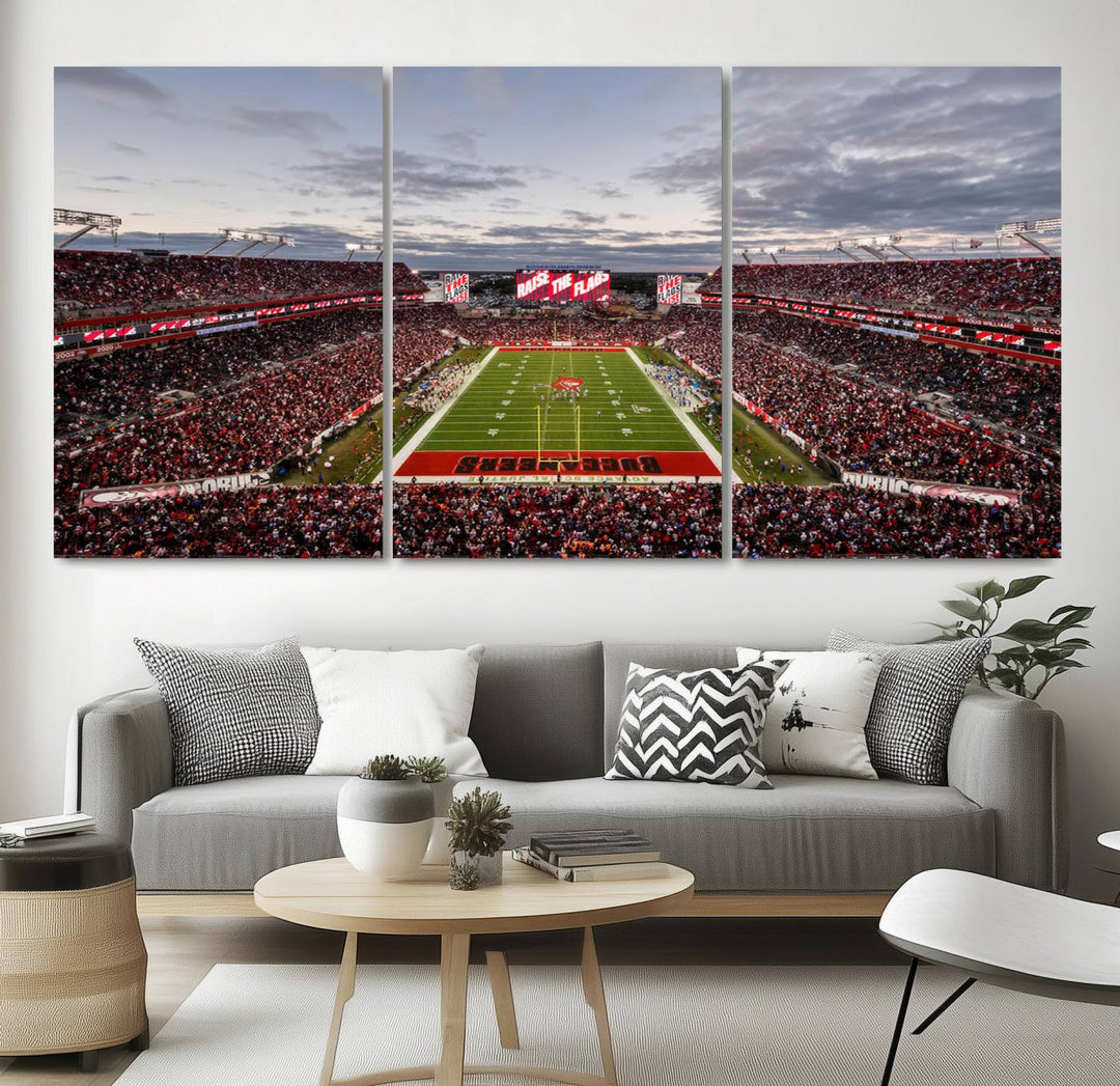 The wall art captures a stunning scene of Raymond James Stadium bathed in the warm hues of sunset. The sky, filled with clouds, provides a dramatic contrast to the vibrant lighting on the field, encapsulating the dynamic energy of a football game.