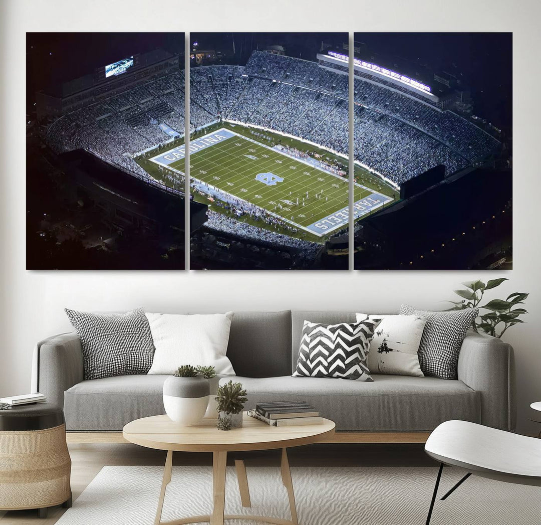 A University of North Carolina Tar Heels Football Team Print, showcasing Chapel Hill's Kenan Memorial Stadium, hangs in a modern dining room, adding a gallery-quality finish that enhances the entire space.