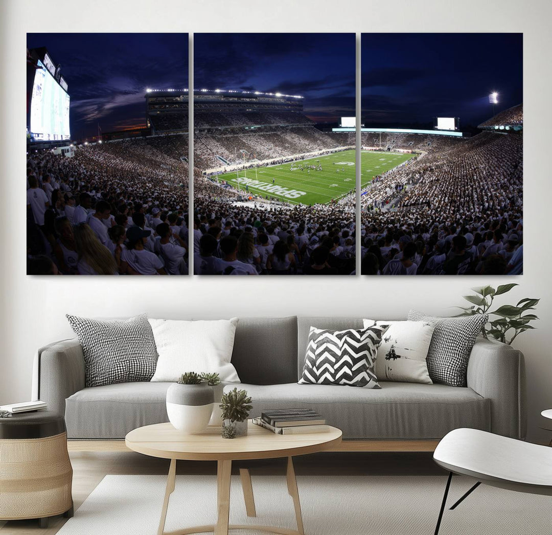 A packed football stadium at night, with bright lights and fans in white, depicted in a Michigan State Spartans Stadium wall art.