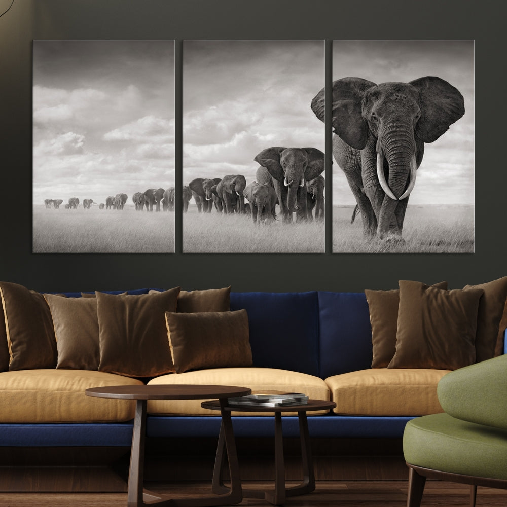 The Elephant Wall Art Canvas Print features a triptych of elephants in a savanna, elegantly displayed.