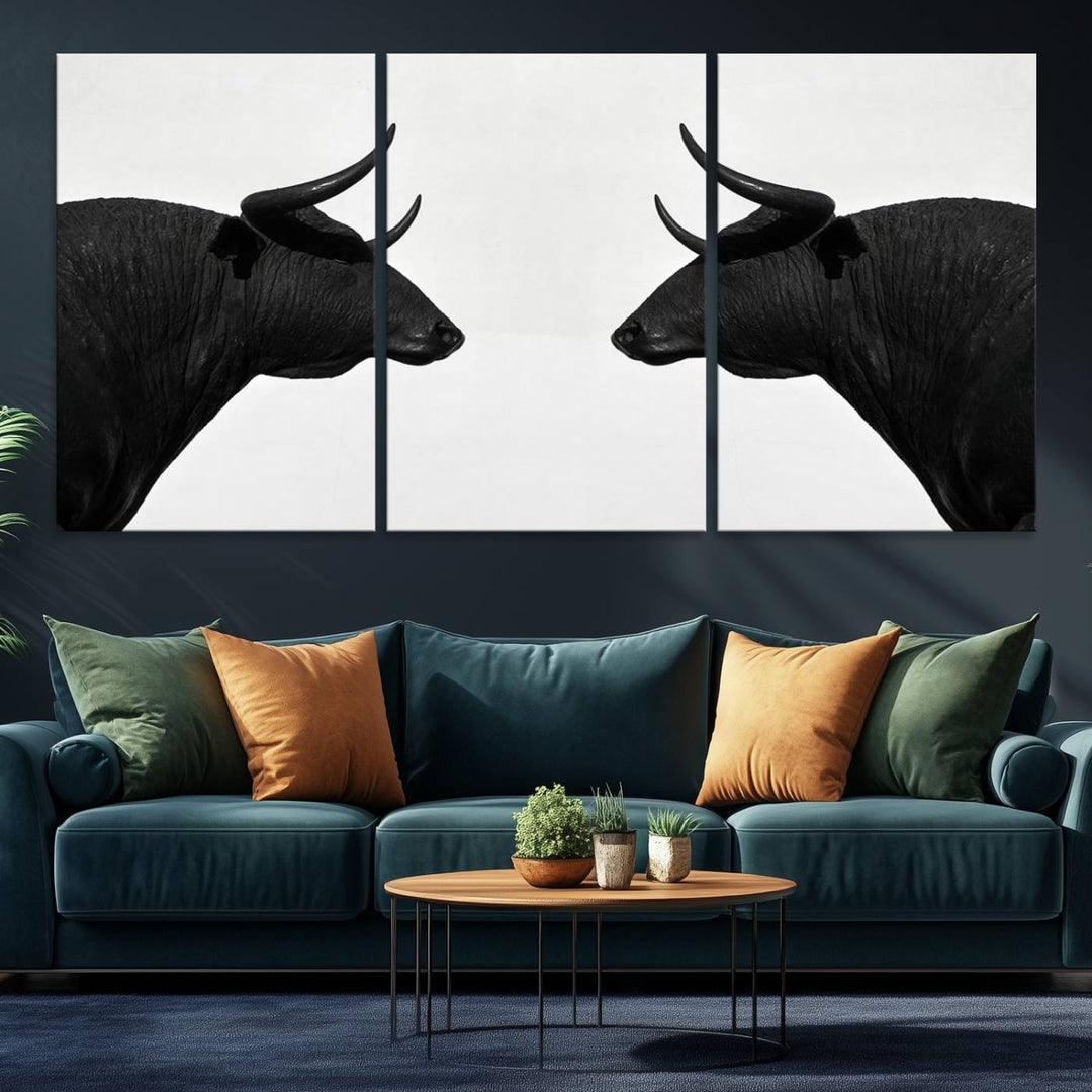 A framed canvas print featuring two black bull silhouettes, perfect for modern rustic decor.